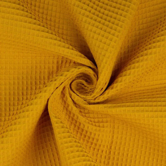Baumwoll Waffelpiqué Stoff in Uni Ocker mit typischer Waffelstruktur, als Meterware gedreht dargestellt